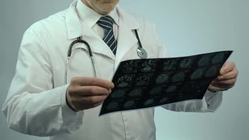 Doctor Examines Brain Scan in Hospital Setting