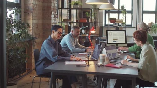 Business People Working at Coworking Table in Office