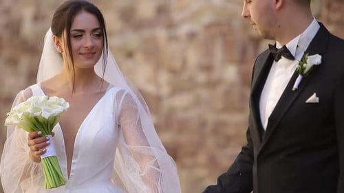 Smiling Bride and Groom Holding Hands