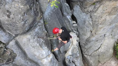 Strong Male Climber Climbing Steep Wall of Rocky Mountain
