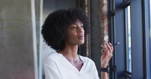 Happy african american woman standing in cafe looking at camera and smiling