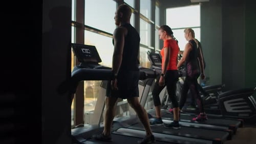 Group of People in the Gym Training on Treadmills in Slow Motion
