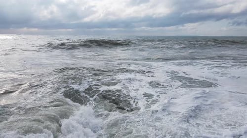 Powerful Waves Forming Breaking on the Shore and Splashing with White Foam