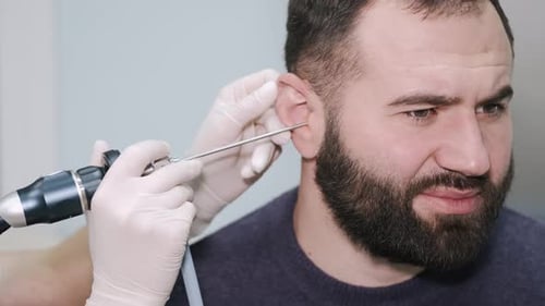Ear Exam with Specialized Tool in Hospital