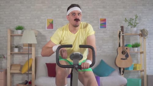 Man Exercising on Stationary Bike at Home