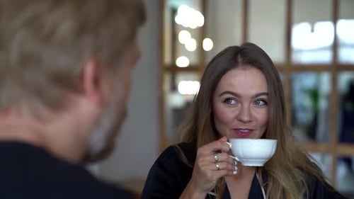 Woman Enjoying Tea and Conversation