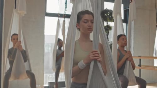 Women Practicing Aerial Yoga for Fitness and Wellness