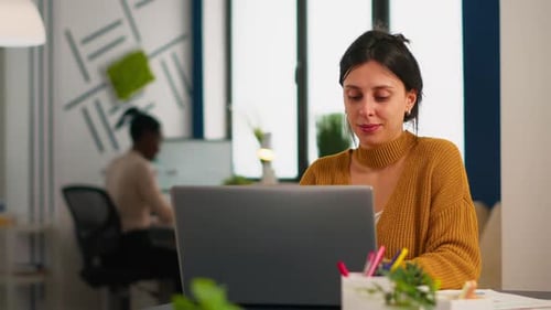 Woman Working on Laptop in Modern Office
