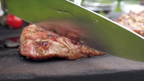 Slicing a Juicy Steak on a Cutting Board