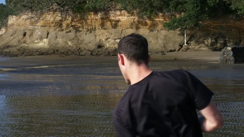 Close up of young man air boxing for fitness at the beach in slow motion