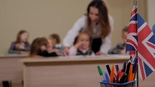 Teacher Assists Students in Elementary School Classroom