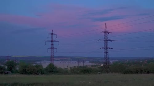 Powerlines Stretch into Dusk Rural Landscape