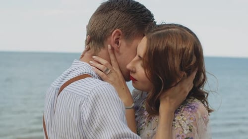 Affectionate Couple Embracing on Sandy Beach
