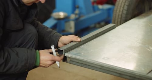 Man Working at Metal Industry - Cutting and Measuring Metal Parts at Workshop