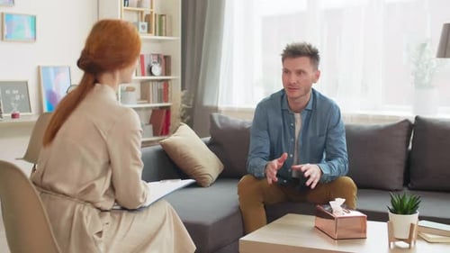 Man Sitting in Office of Psychologist