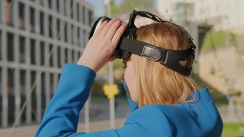 Woman Using Virtual Reality Headset in Urban Setting