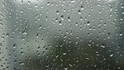 Raindrops Run Down the Window Pane on a Rainy Day
