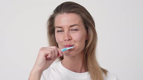 Woman Brushing Teeth Close Up