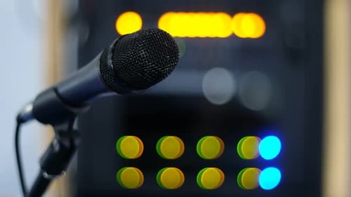 Studio Microphone with Blurred Audio Equipment Background