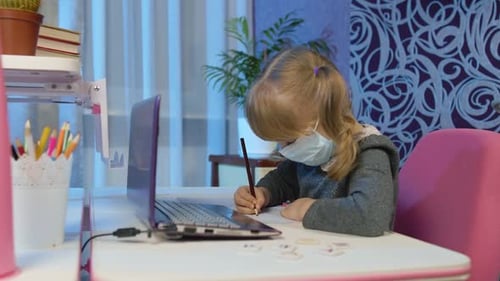 Girl Wearing Mask Doing Homework at Desk