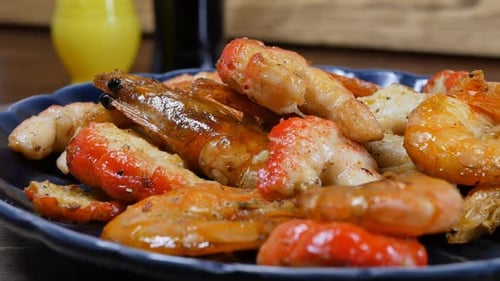 Shrimps Fried in Oil Until Golden Crust Rotation in a Blue Ceramic Plate