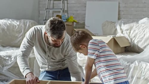 Father and Son Assembling Furniture Together