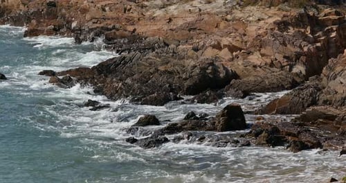 Sea water wave with stone cliff