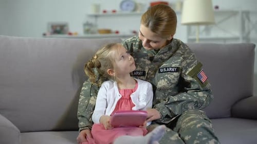 Woman in Uniform with Child on Couch