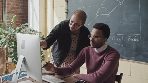 Woman Helping Colleague on Project
