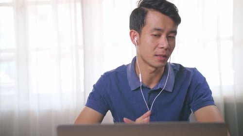 Young Adult Talking on Laptop in Home Setting