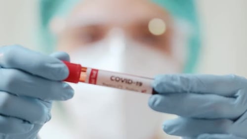 COVID-19 Positive Blood Sample Held by Medical Worker
