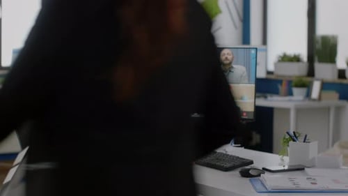 Man Attends Video Conference in a Modern Office