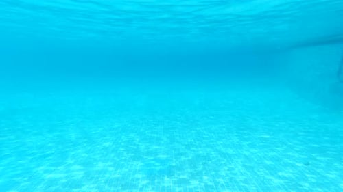 Pure Blue Water in the Pool with Light Reflections