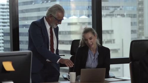 Man and Woman Discussing Work at Desk