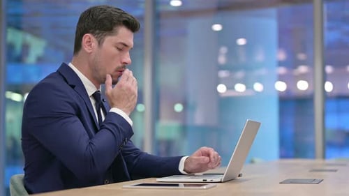 Adult Man Working on Laptop in Office at Night