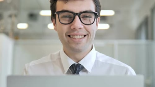 Smiling Businessman, Frontal View at Work