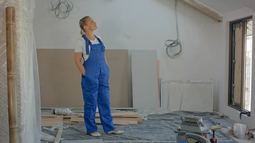 Woman Standing in Room Undergoing Renovation