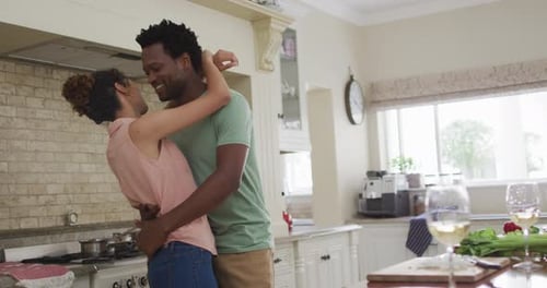 Happy Couple Embracing in a Kitchen