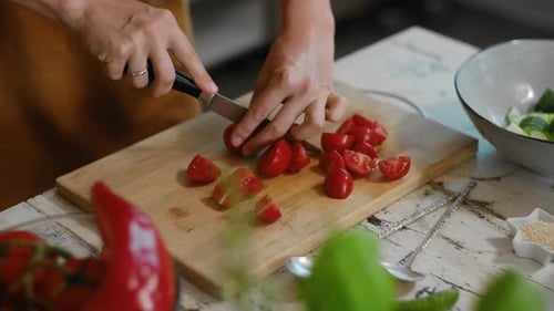 Woman Cuts Fresh Tomatoes for a Salad