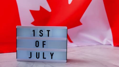 Canada Day Sign and Flag Close Up