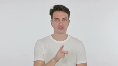 Silence Please Young Man with Finger on Lips on White Background