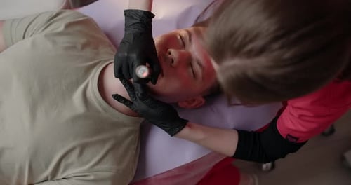 Young Adult Receiving Facial Skin Treatment