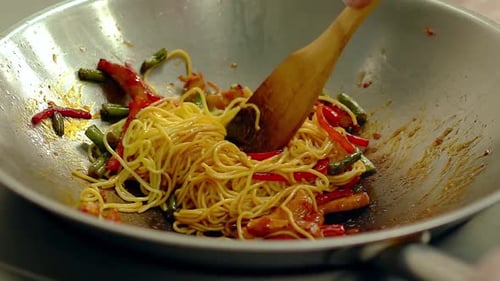 Spaghetti Stir-Fry in a Wok being stirred