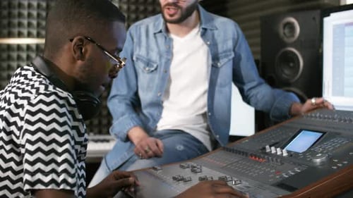 Record Producer and Sound Engineer Mixing Music