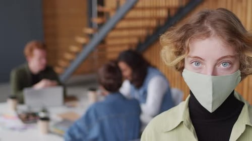 Young Woman with Face Mask in Office Environment