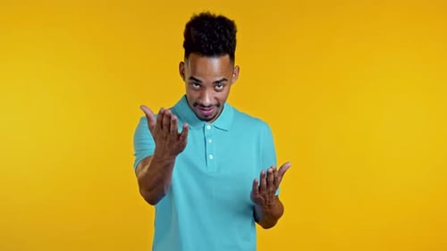 Handsome African Man Showing - Hey You, Come Here. Guy Asks Join Him, Beckons with Inviting Hand