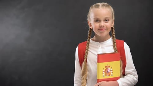 Girl Holding Spanish Flag Book Smiling Portrait