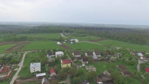 Small Village with Low Houses Near the Forest. Aerial View