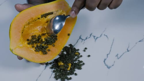 Scooping Papaya Seeds