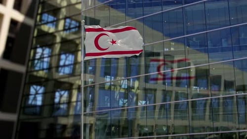 Northern Cyprus Flag Waving in Front of Modern Building